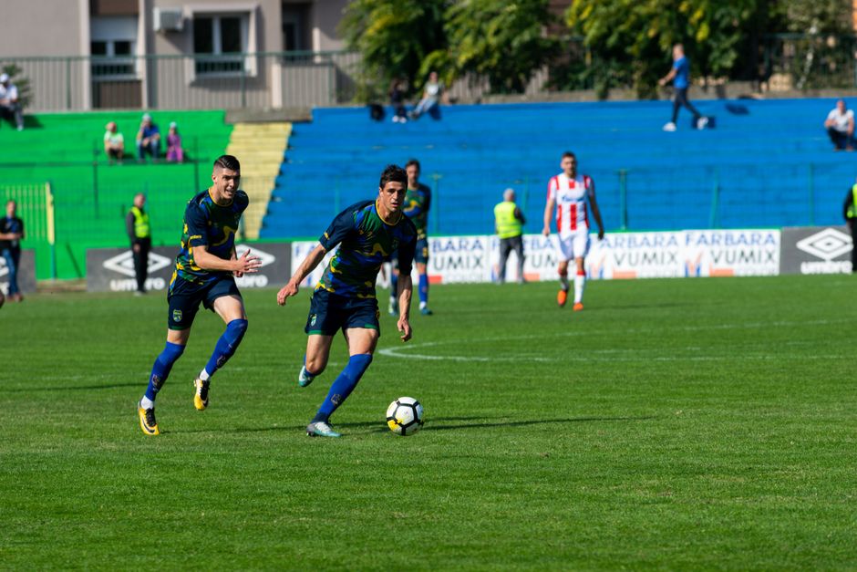 Dynamic soccer match with players in action on the field, highlighting teamwork and competition.